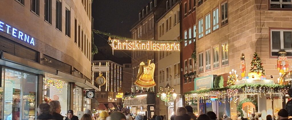 An image of a street in Nuremberg with a Christkindlesmarkt banner